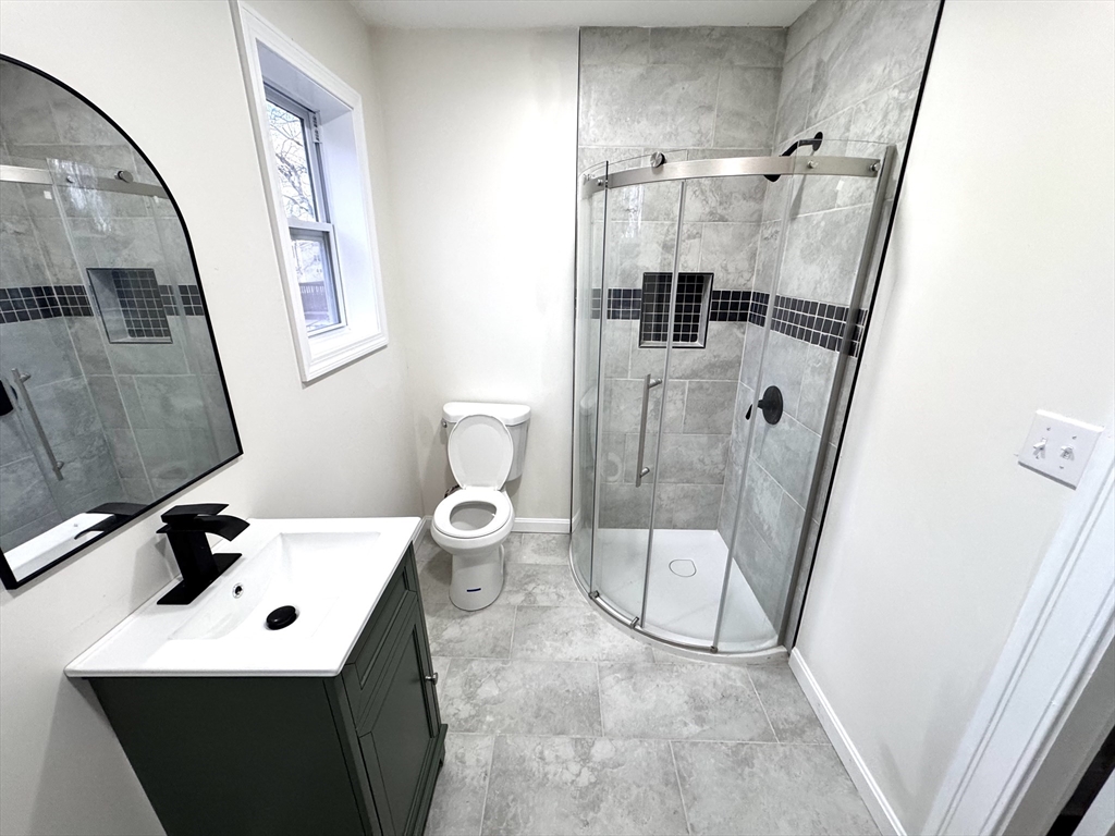 9 Idalla Avenue Worcester, MA 01606 - Photo 11 of 16 a bathroom with a sink mirror and toilet