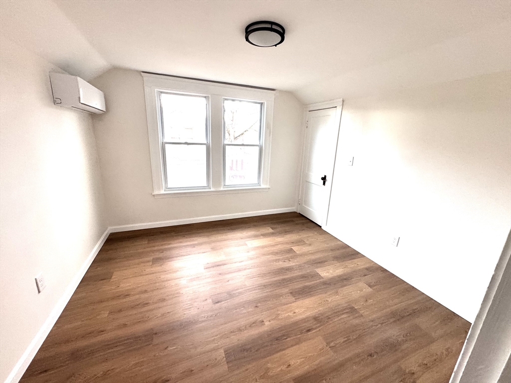9 Idalla Avenue Worcester, MA 01606 - Photo 12 of 16 an empty room with wooden floor and windows