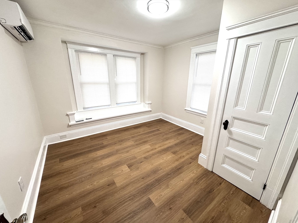 9 Idalla Avenue Worcester, MA 01606 - Photo 6 of 16 an empty room with wooden floor and window