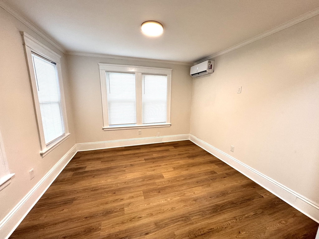 9 Idalla Avenue Worcester, MA 01606 - Photo 7 of 16 an empty room with wooden floor and windows