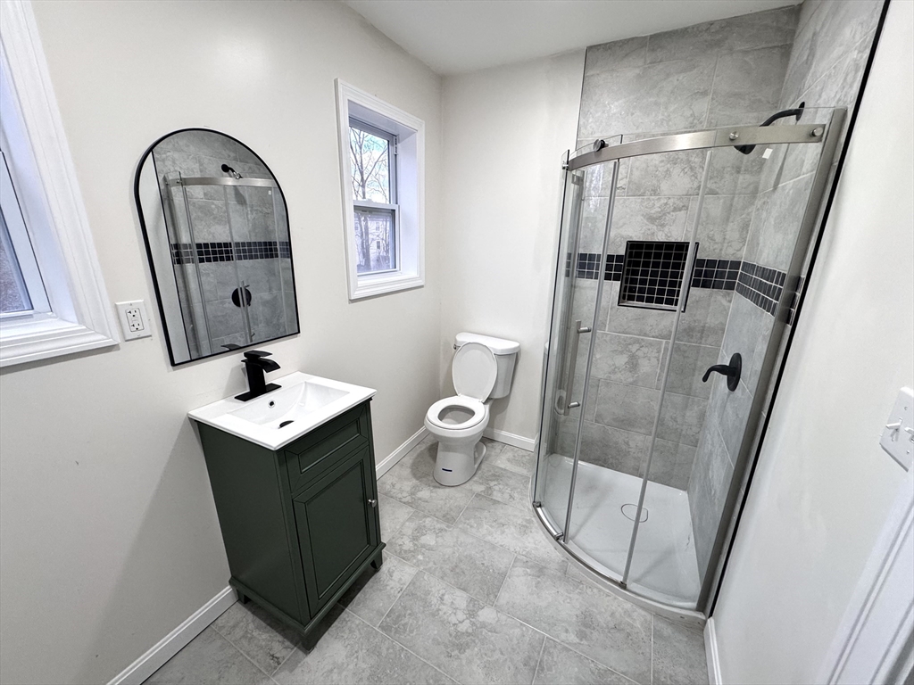 9 Idalla Avenue Worcester, MA 01606 - Photo 10 of 16 a bathroom with a toilet sink and mirror