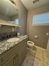 13907 Buffalo Speedway Houston, TX 77045 - Photo 8 of 14 a bathroom with a granite countertop sink a toilet and a mirror