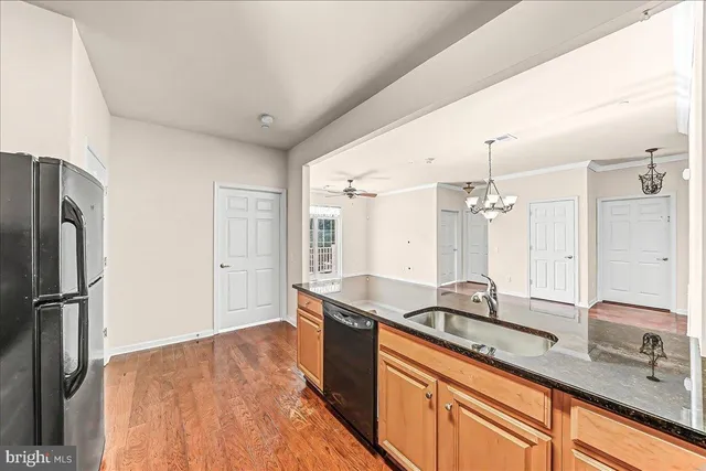 a kitchen with stainless steel appliances granite countertop a sink refrigerator and cabinets