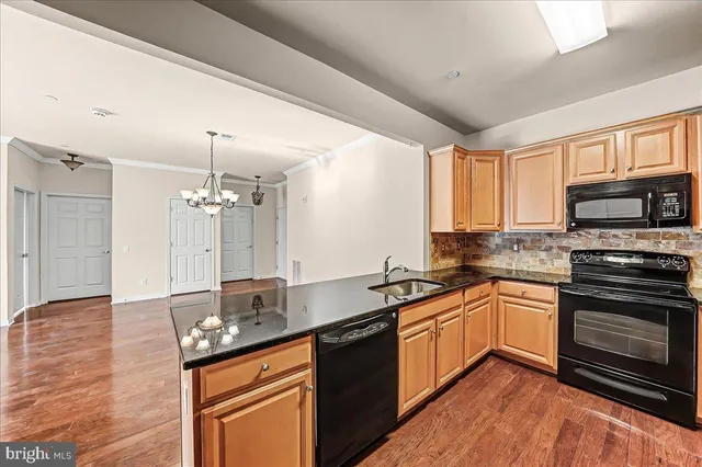 a kitchen with stainless steel appliances granite countertop a sink stove and microwave