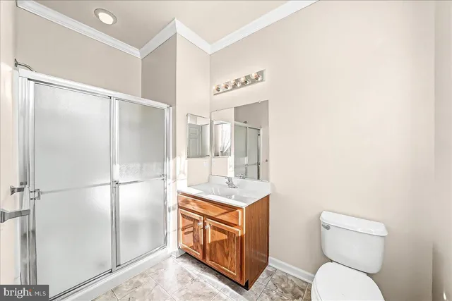 a bathroom with a toilet sink and shower