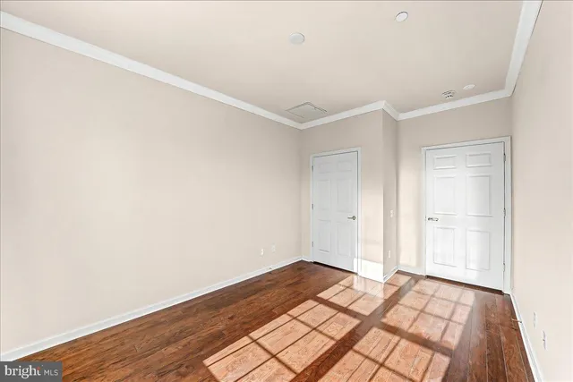 a view of a room with wooden floor and closet
