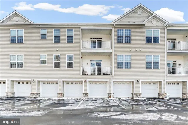 a front view of a house with a street
