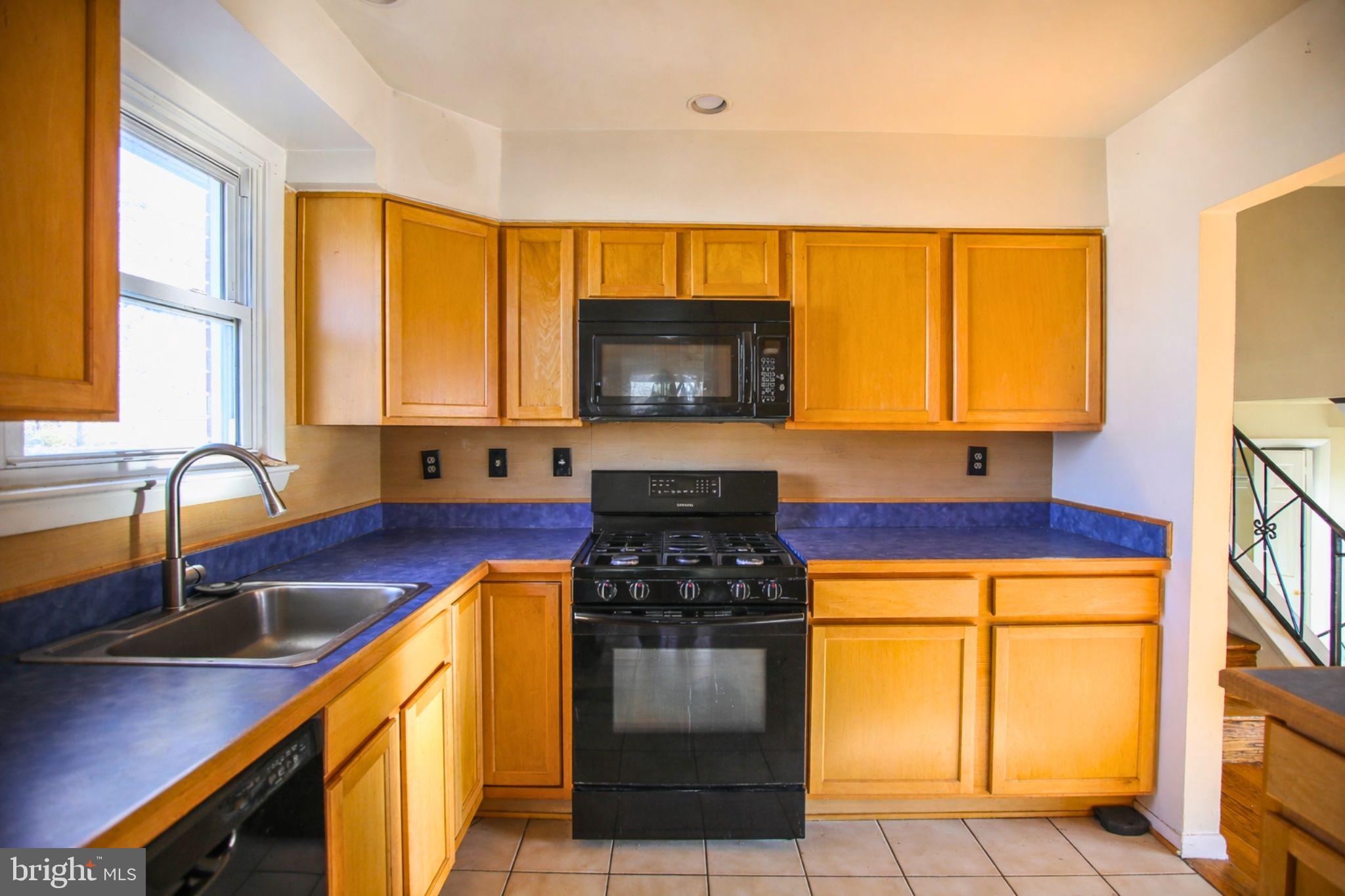 7920 Denton Drive Clinton, MD 20735 - Photo 18 of 34 a kitchen with stainless steel appliances a stove a sink and a microwave