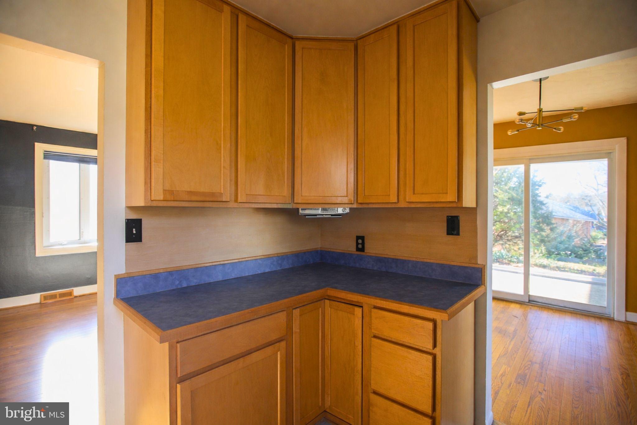 7920 Denton Drive Clinton, MD 20735 - Photo 20 of 34 a kitchen with stainless steel appliances granite countertop wooden cabinets a sink and a large window