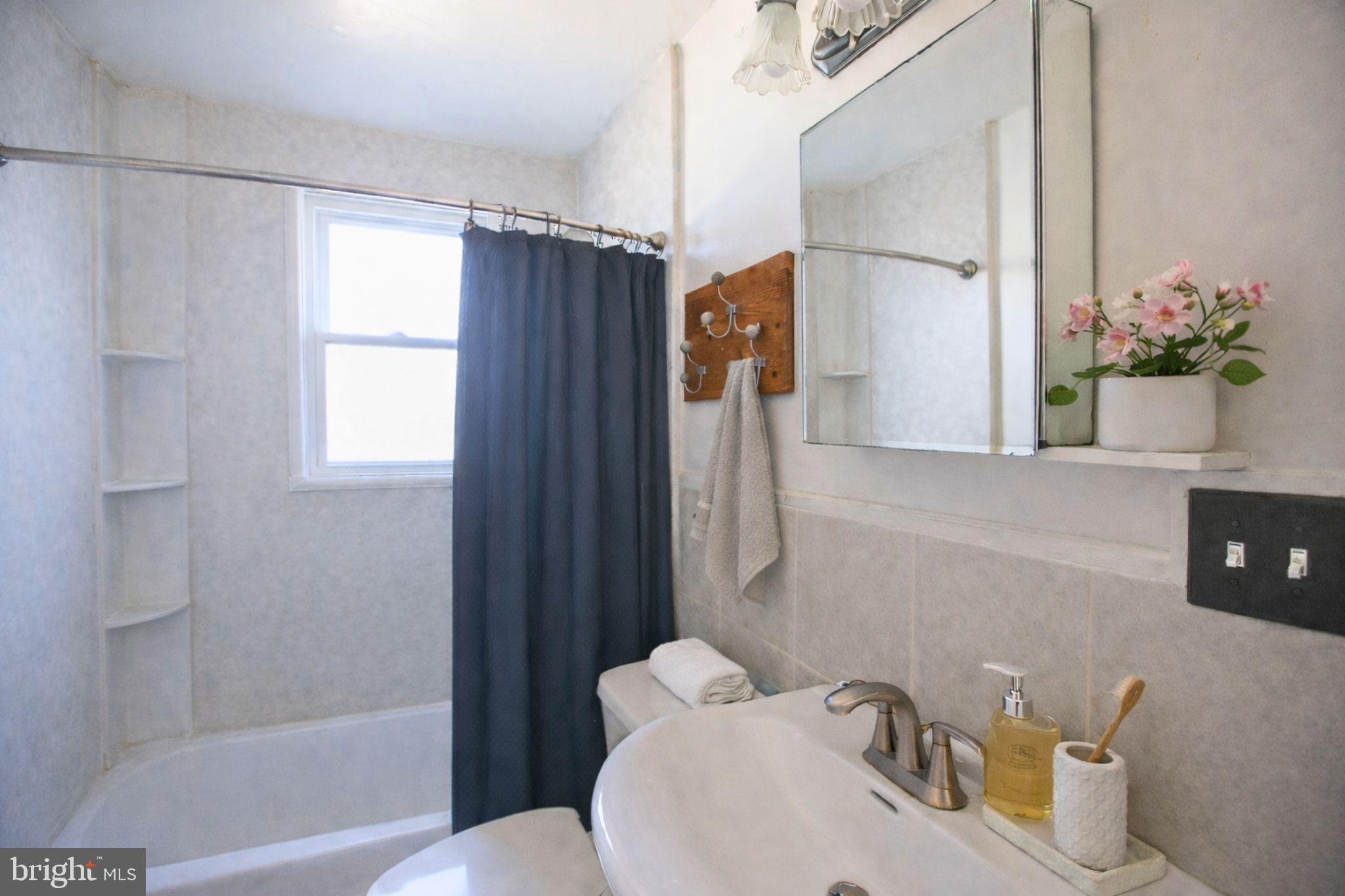 7920 Denton Drive Clinton, MD 20735 - Photo 32 of 34 a bathroom with a sink toilet and shower