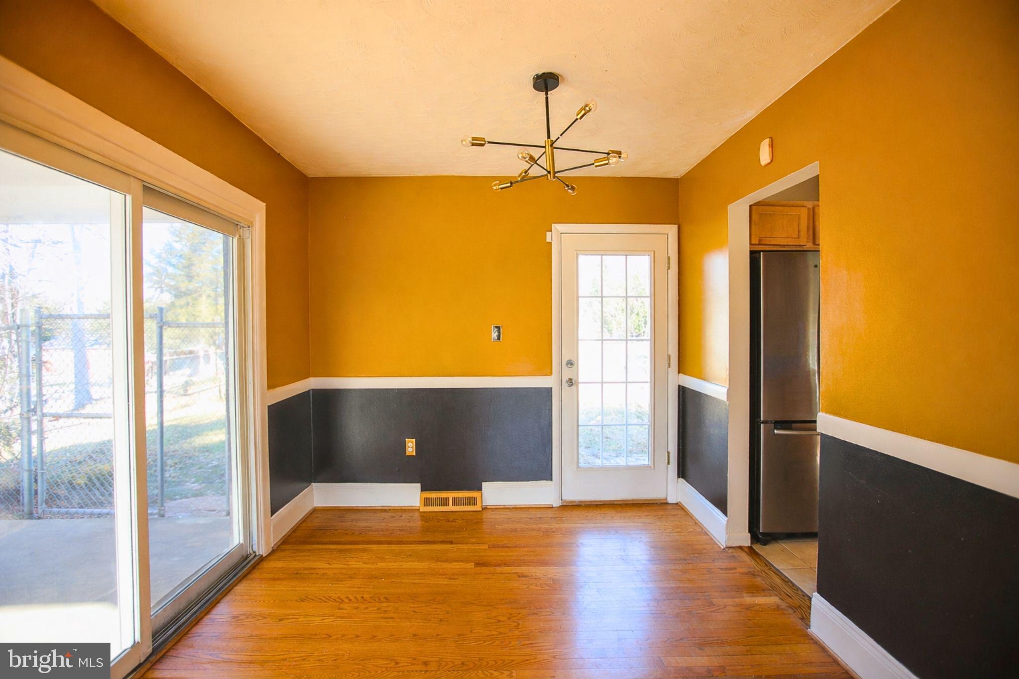 7920 Denton Drive Clinton, MD 20735 - Photo 8 of 34 a view of an empty room with window and wooden floor