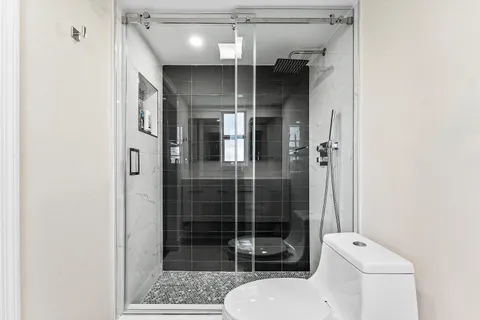 a bathroom with a toilet and a shower