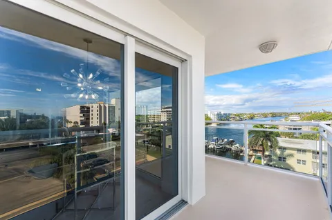 a view of a balcony dining room and kitchen view