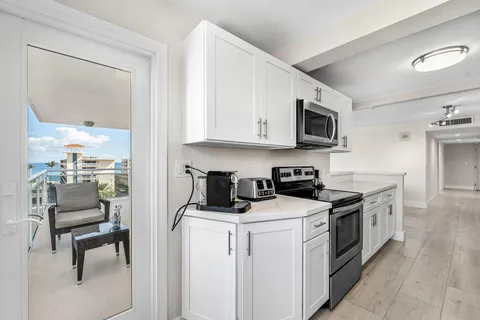 a kitchen with stainless steel appliances a stove a sink and a microwave