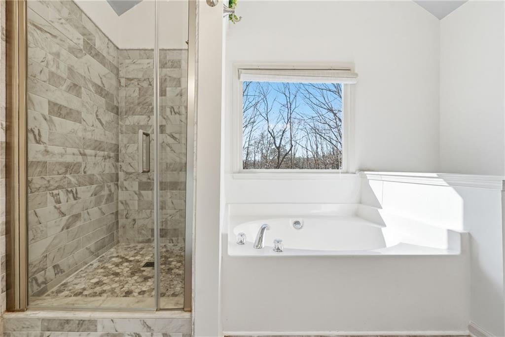 432 Barrel Way Ball Ground, GA 30107 - Photo 19 of 50 a bathroom with a bathtub and shower