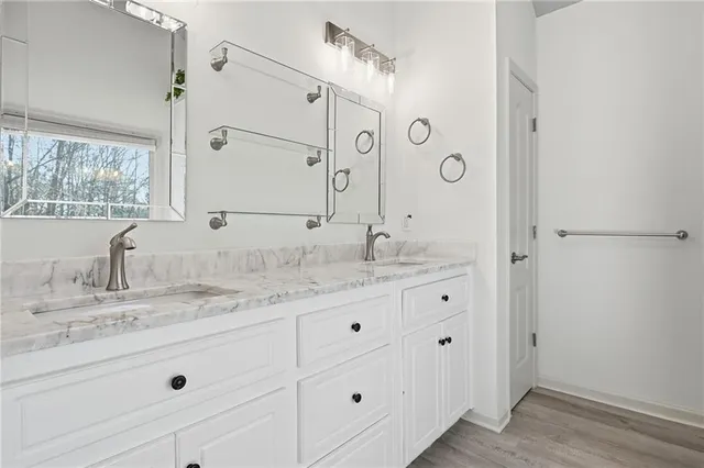a bathroom with a granite countertop sink mirror and double