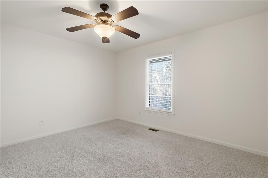 432 Barrel Way Ball Ground, GA 30107 - Photo 21 of 50 an empty room with a window and a fan