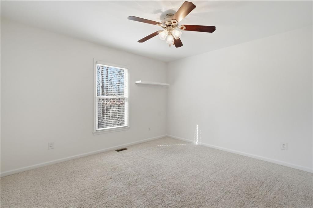 432 Barrel Way Ball Ground, GA 30107 - Photo 22 of 50 an empty room with a window and a fan