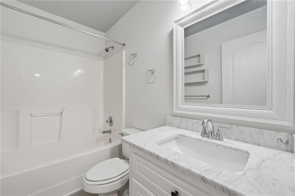 432 Barrel Way Ball Ground, GA 30107 - Photo 23 of 50 a bathroom with a granite countertop sink toilet and shower