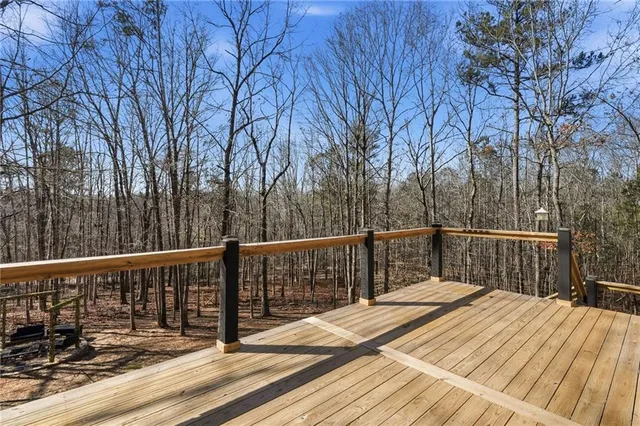 a view of balcony with wooden floor and fence