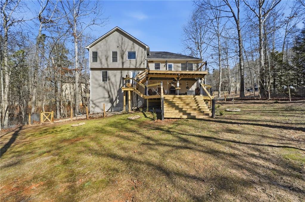 432 Barrel Way Ball Ground, GA 30107 - Photo 36 of 50 a view of a house with large trees and wooden fence