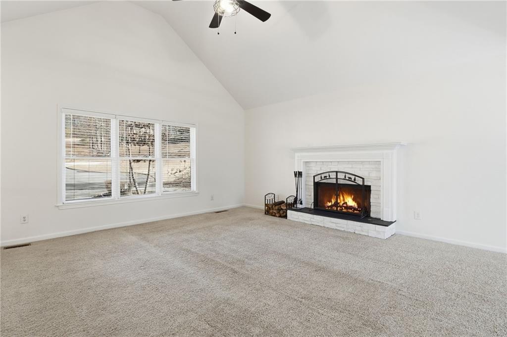 432 Barrel Way Ball Ground, GA 30107 - Photo 4 of 50 an empty room with fireplace and window