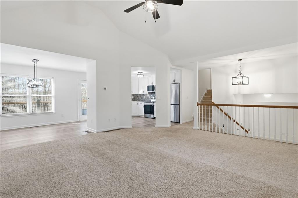 432 Barrel Way Ball Ground, GA 30107 - Photo 5 of 50 a view of an empty room with a window and kitchen view