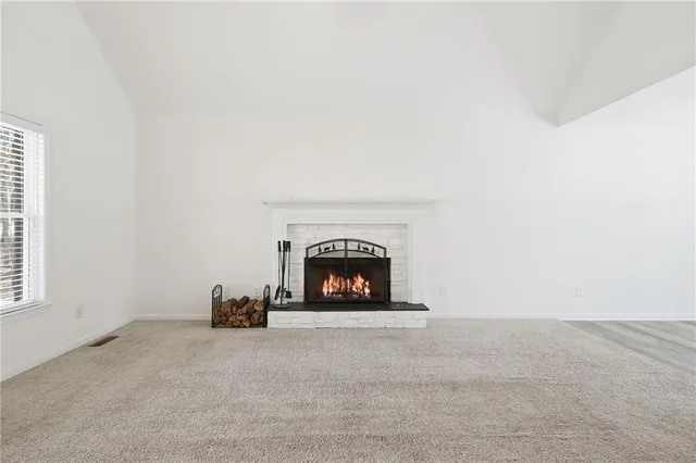 a view of an empty room with a fireplace