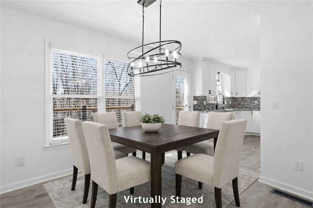 432 Barrel Way Ball Ground, GA 30107 - Photo 8 of 50 a view of a dining room with furniture window and wooden floor