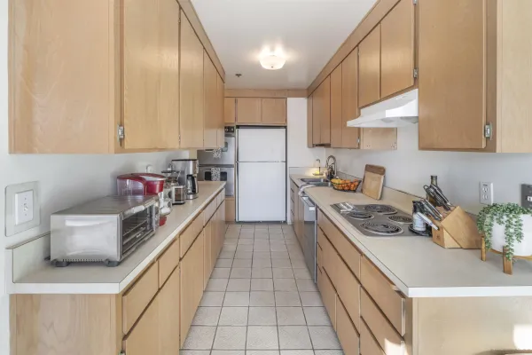 a kitchen with stainless steel appliances granite countertop a sink stove and cabinets