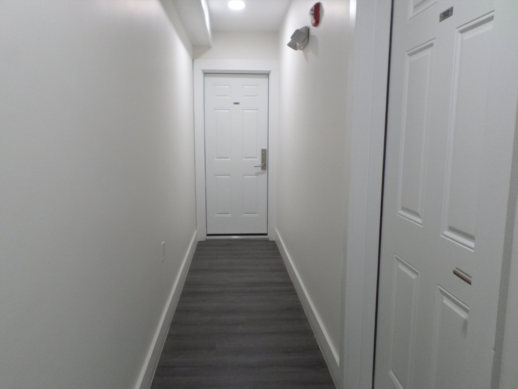 267 Broadway Chelsea, MA 02150 - Photo 11 of 30 a view of a hallway with the wooden floor