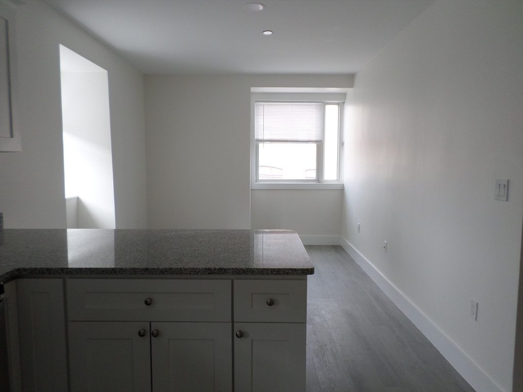 267 Broadway Chelsea, MA 02150 - Photo 10 of 30 a room with a window and cabinets