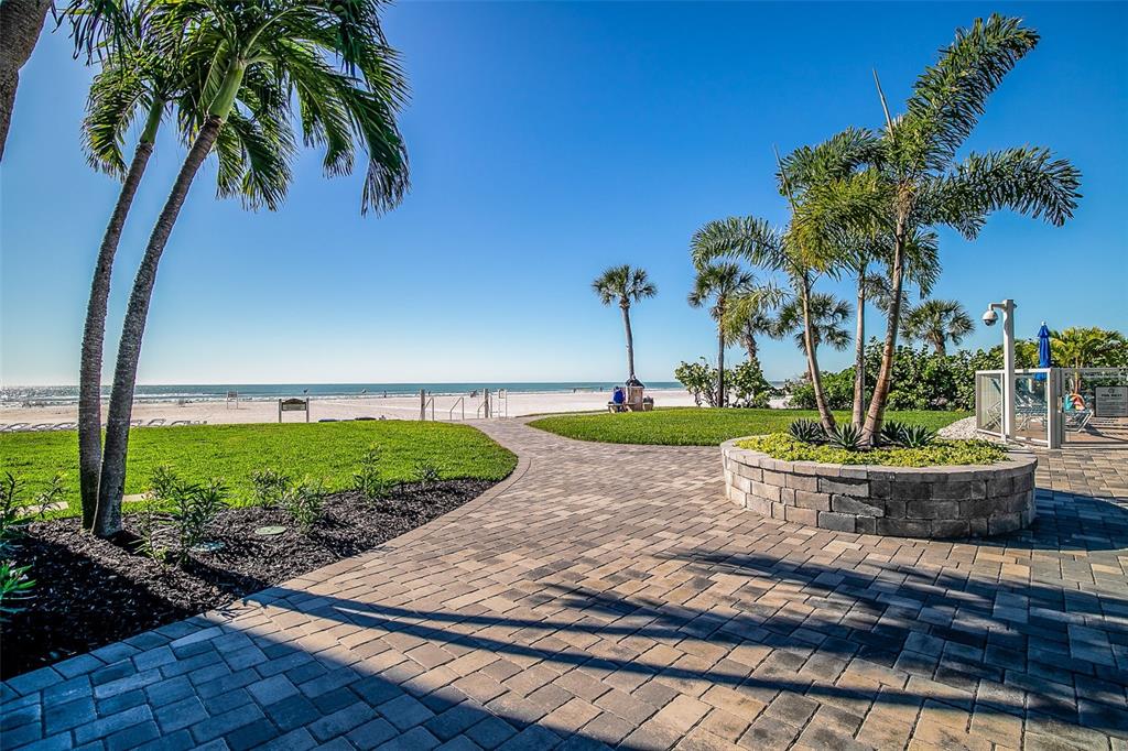 6300 Midnight Pass Road, Unit 21 Sarasota, FL 34242 - Photo 27 of 30 a view of a backyard with plants and palm trees