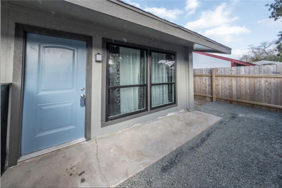 2610 Ektom Drive, Unit B Austin, TX 78745 - Photo 1 of 13 Doorway to property featuring fence