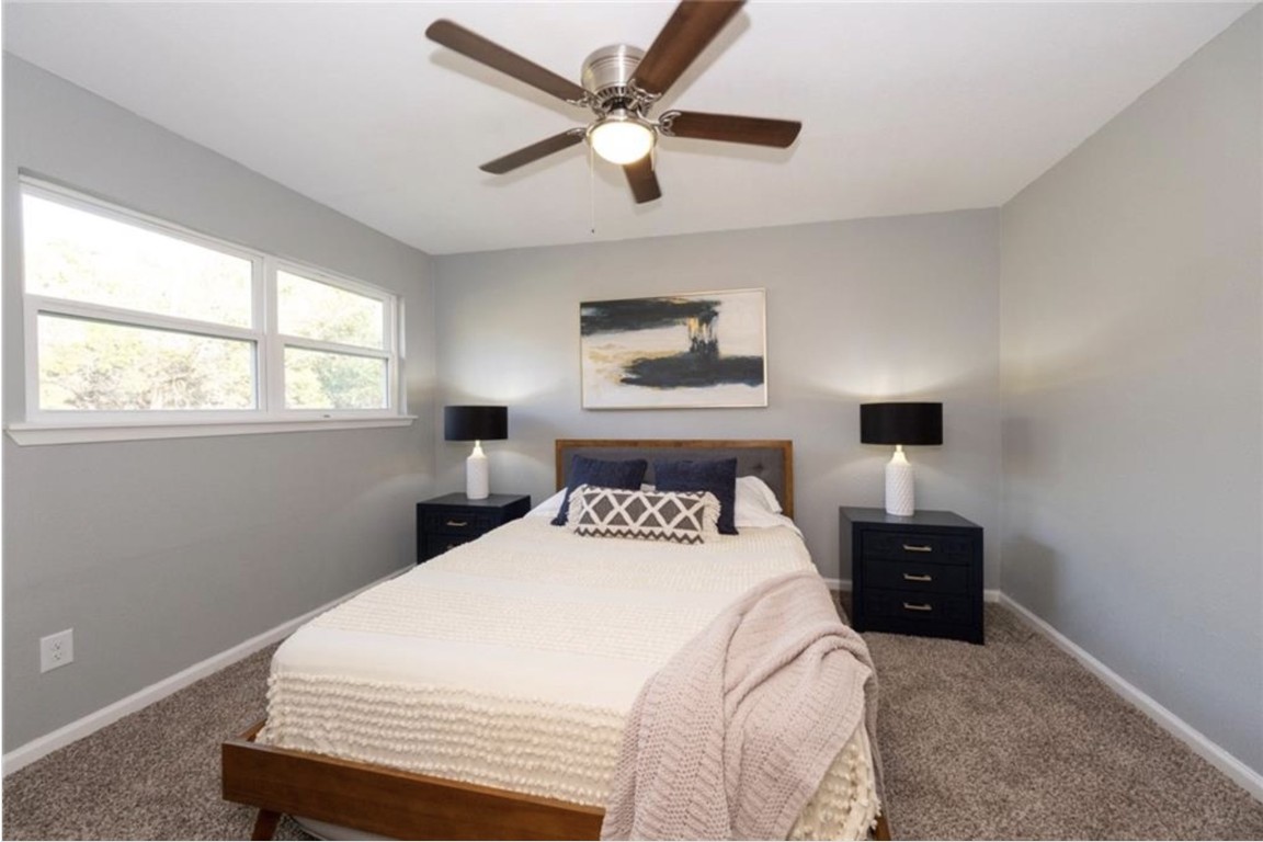 2610 Ektom Drive, Unit B Austin, TX 78745 - Photo 11 of 13 Carpeted bedroom featuring baseboards and ceiling fan