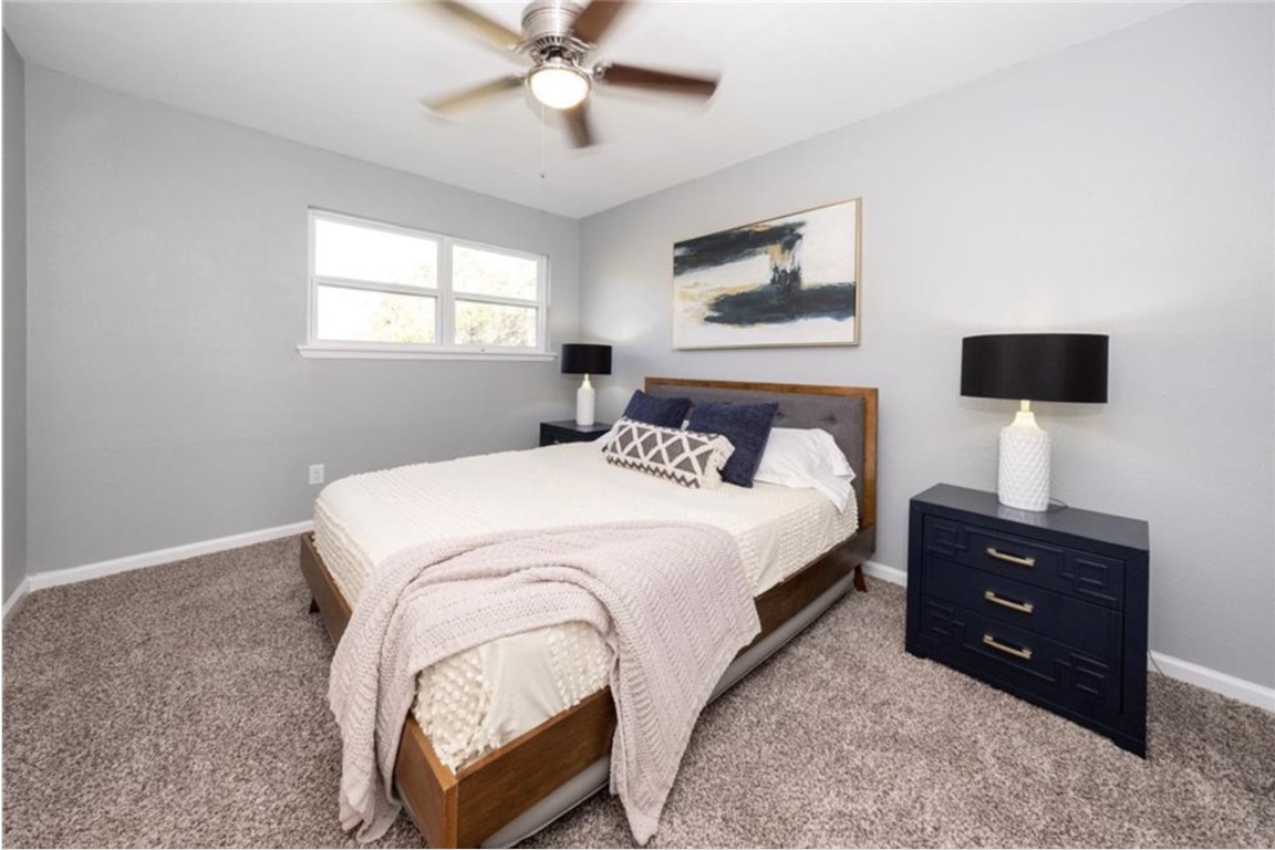 2610 Ektom Drive, Unit B Austin, TX 78745 - Photo 12 of 13 Bedroom featuring light carpet, a ceiling fan, and baseboards