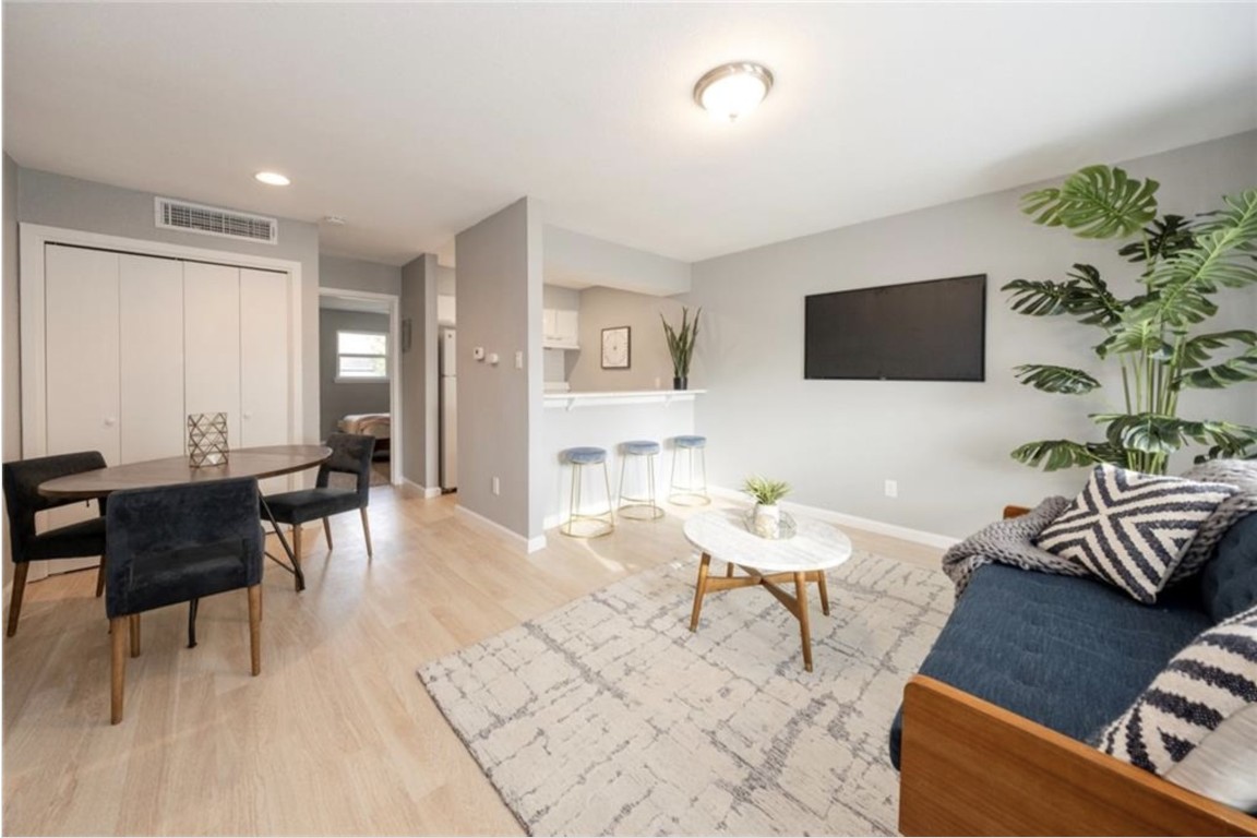 2610 Ektom Drive, Unit B Austin, TX 78745 - Photo 2 of 13 Living room with baseboards, wood finished floors, visible vents, and recessed lighting