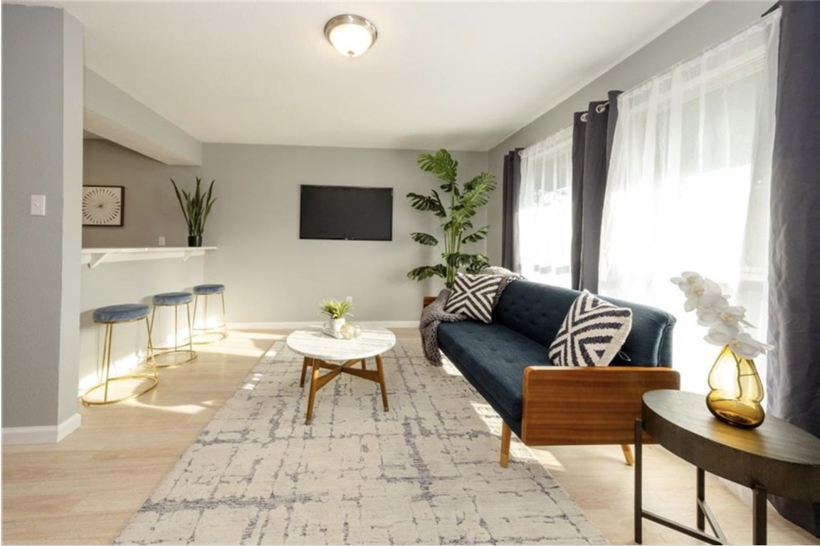 2610 Ektom Drive, Unit B Austin, TX 78745 - Photo 5 of 13 Living area featuring baseboards and wood finished floors