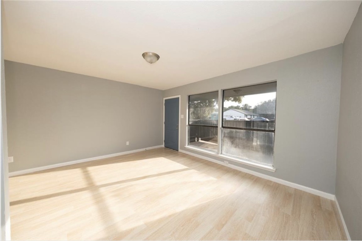 2610 Ektom Drive, Unit B Austin, TX 78745 - Photo 6 of 13 Empty room with baseboards and wood finished floors