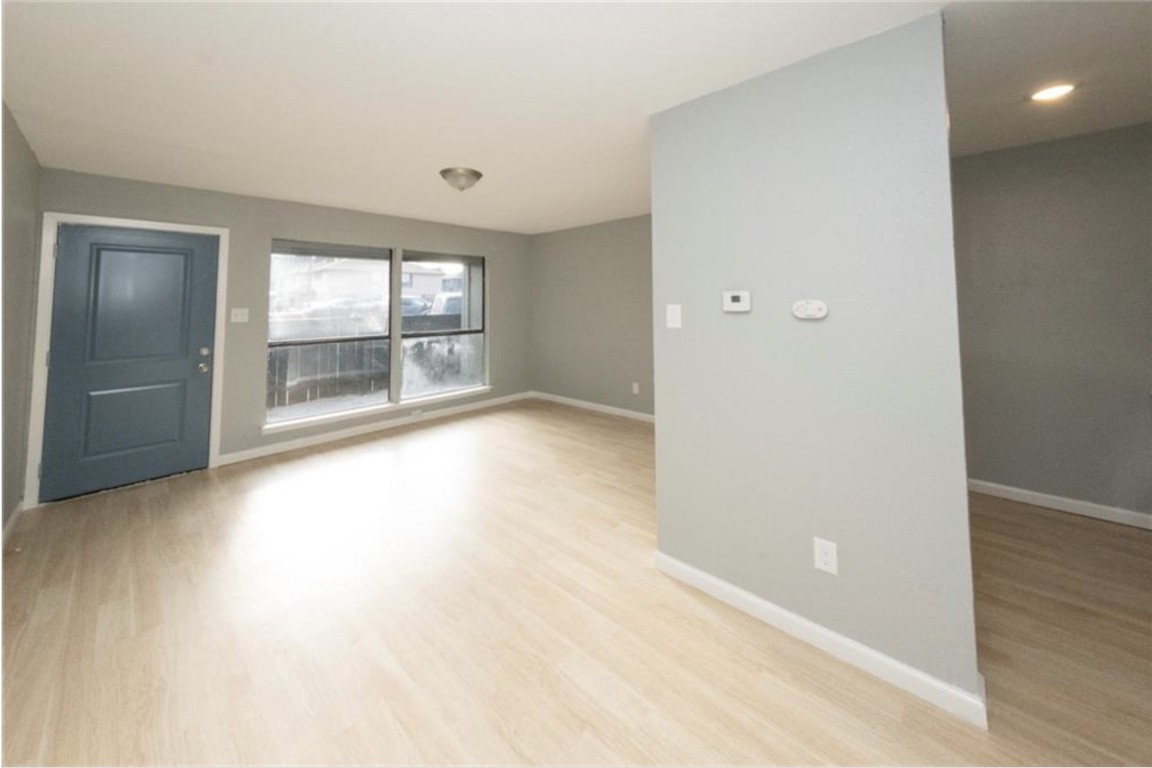 2610 Ektom Drive, Unit B Austin, TX 78745 - Photo 7 of 13 Unfurnished room featuring baseboards and light wood-style flooring
