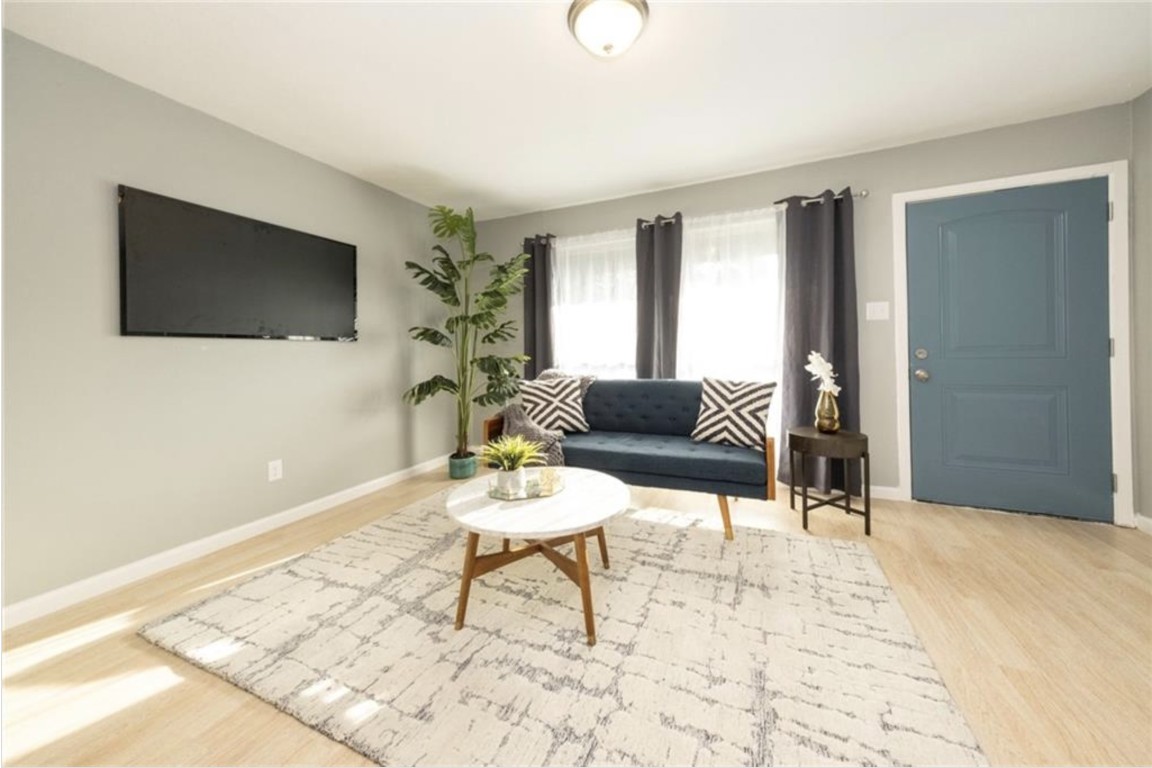 2610 Ektom Drive, Unit B Austin, TX 78745 - Photo 8 of 13 Living room with baseboards and wood finished floors