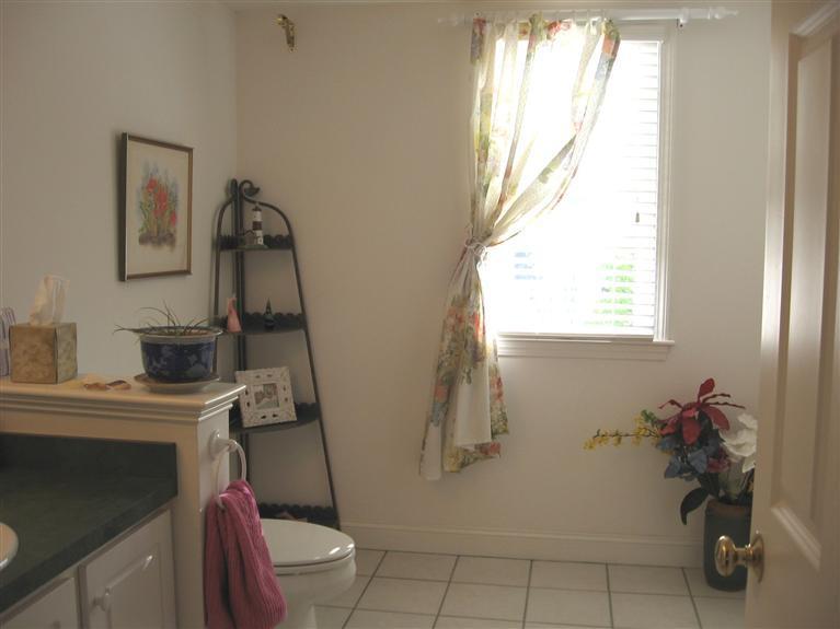 56 Stratford Ridge, Unit 148 Mashpee, MA 02649 - Photo 20 of 29 a bathroom with a toilet sink and mirror