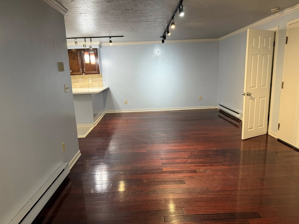 11 Hulbert Road, Unit 15 Worcester, MA 01603 - Photo 7 of 9 an empty room with wooden floor and windows
