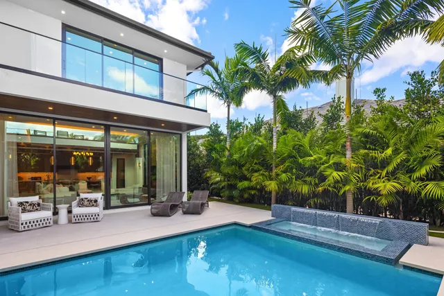 a living room with furniture large window and flat screen tv