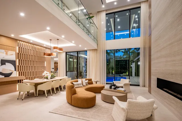 a living room with furniture kitchen view and a chandelier