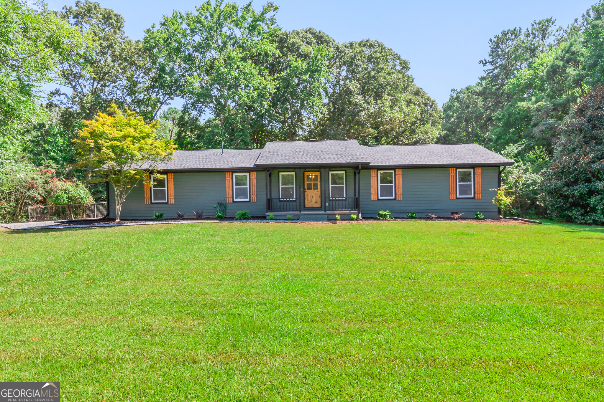 1126 Cedar Creek Road Newnan, GA 30263 - Photo 1 of 1 a front view of a house with a garden