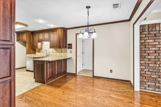 a view of a kitchen with a sink stainless steel appliances and cabinets