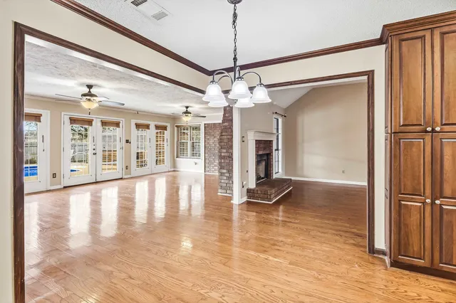 a view of an entryway with wooden floor