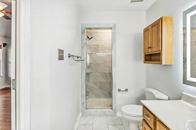 a white toilet sitting next to a bathroom sink