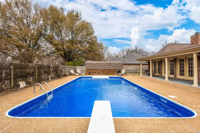 a view of outdoor space with swimming pool and seating